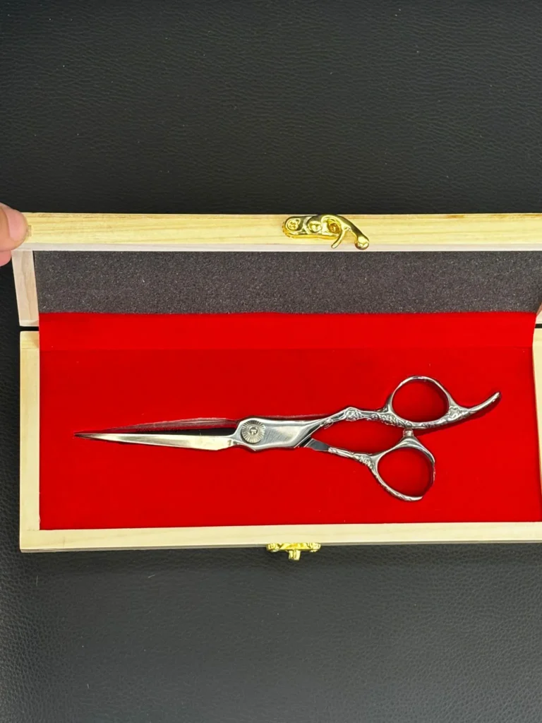 Close-up of ergonomic offset handle hair cutting shears designed for professional barbers and stylists.